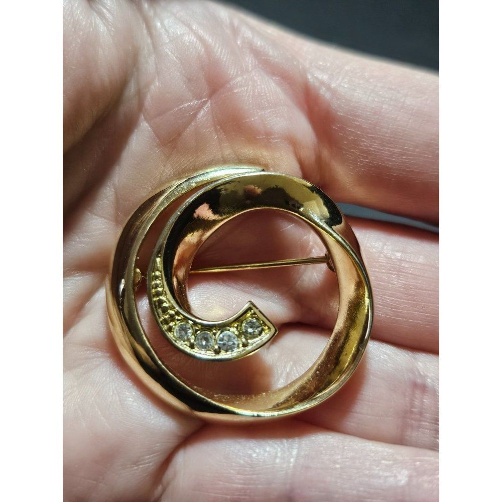 Vintage gold tone circular swirl brooch